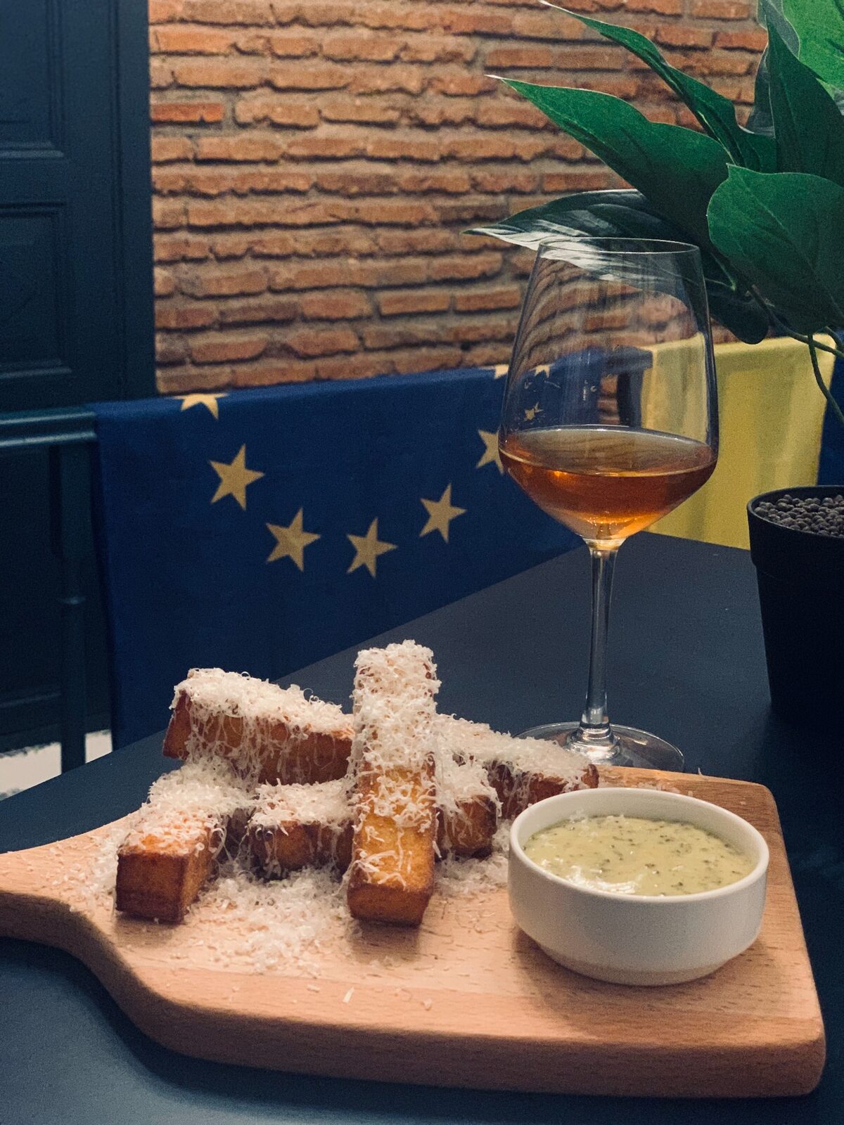 Polenta and Parmesan chips with dipping sauce and wine