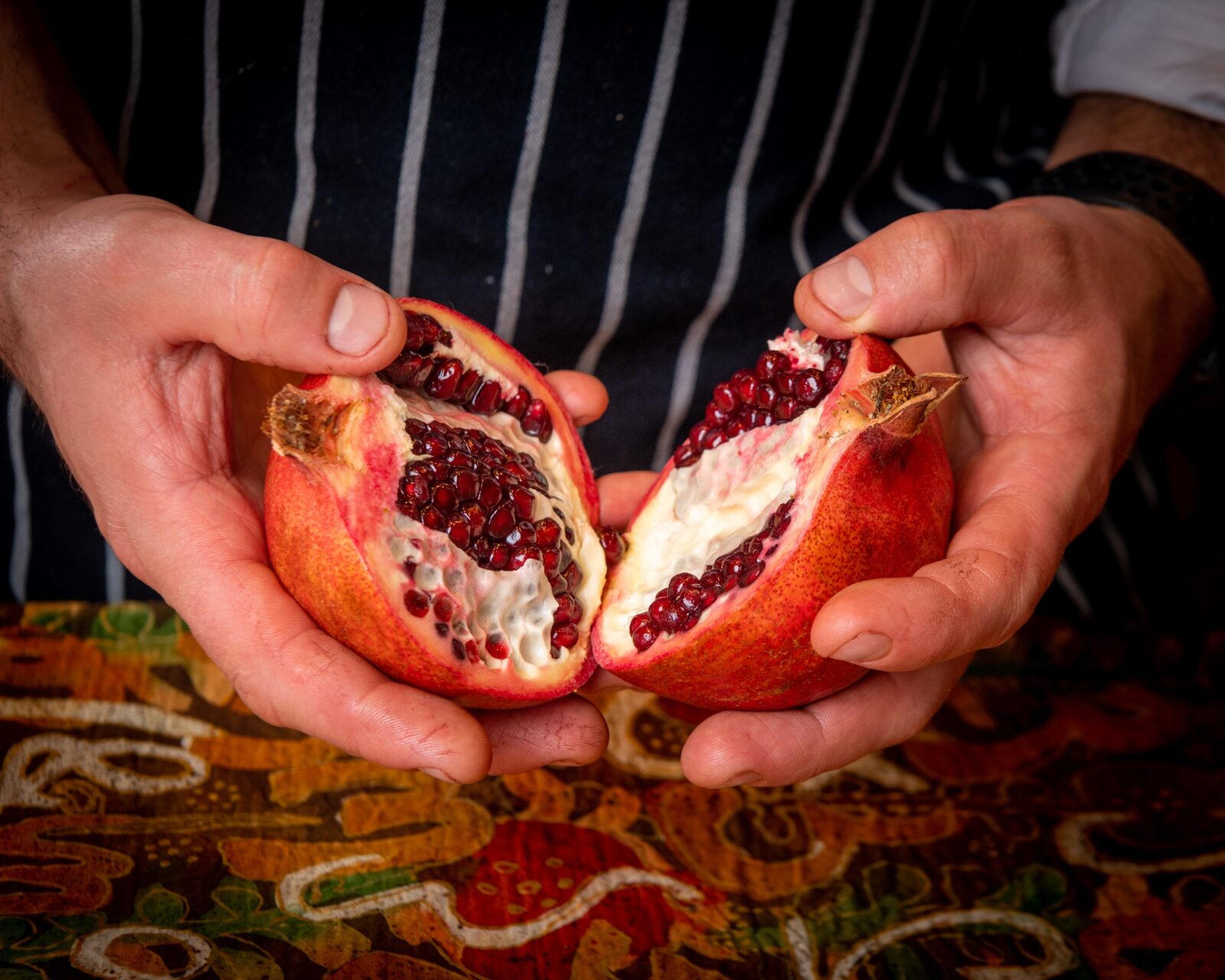 Chef Paata opening a ripe Georgian pomegranate